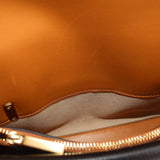 Leather bag interior with tan lining and gold zipper pull detail