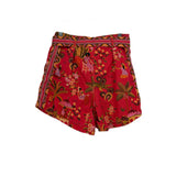 Coral-red print shorts with tie waist and colorful animal and floral pattern