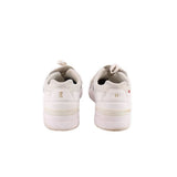 White sneakers heel view with cushioned collar and logo on back tab