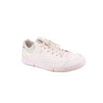 White low-top sneakers with lace-up front, perforated detailing, and rubber cupsole