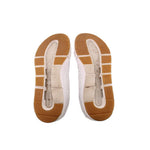 White sneaker outsoles with textured rubber tread in tan and light gray