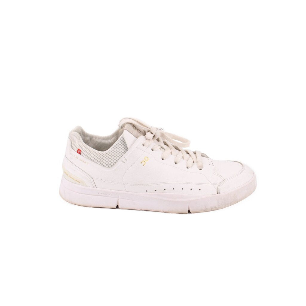 White low-top sneakers with mesh side panels, lace-up closure, and padded collar