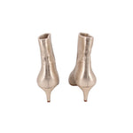 Pair of metallic gold ankle booties, back view, slim heel