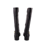 Black knee-high leather boots from back view with gold side buckle