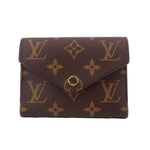 Louis Vuitton Victorine monogram wallet in dark brown with gold-tone logo flap and snap