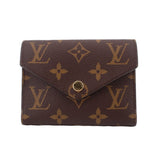 Louis Vuitton Victorine monogram wallet in dark brown with gold-tone logo flap and snap