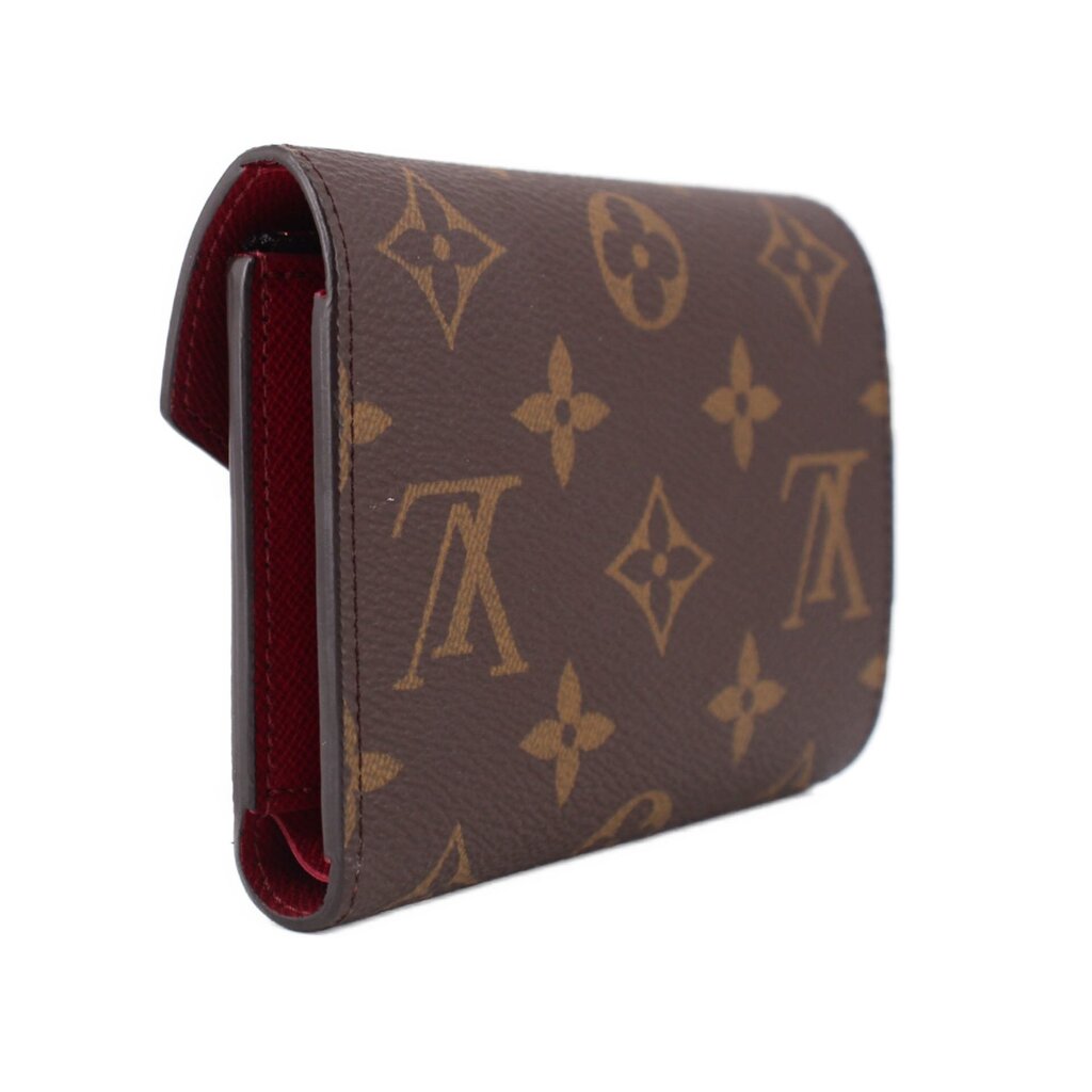 Louis Vuitton Victorine monogram wallet angled view with red fabric lining at edge