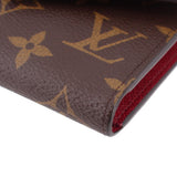 Louis Vuitton Victorine monogram wallet corner close-up with brown exterior and red lining
