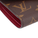 Louis Vuitton Victorine monogram wallet edge close-up with red interior lining and stitching