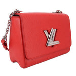 Twist MM crossbody bag in red textured leather with flap and LV emblem