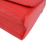 Twist MM crossbody bag close-up corner with red textured finish and stitching