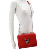 Twist MM crossbody bag on mannequin in red textured leather with LV emblem