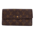 Louis Vuitton monogram flap wallet with gold-tone snap button