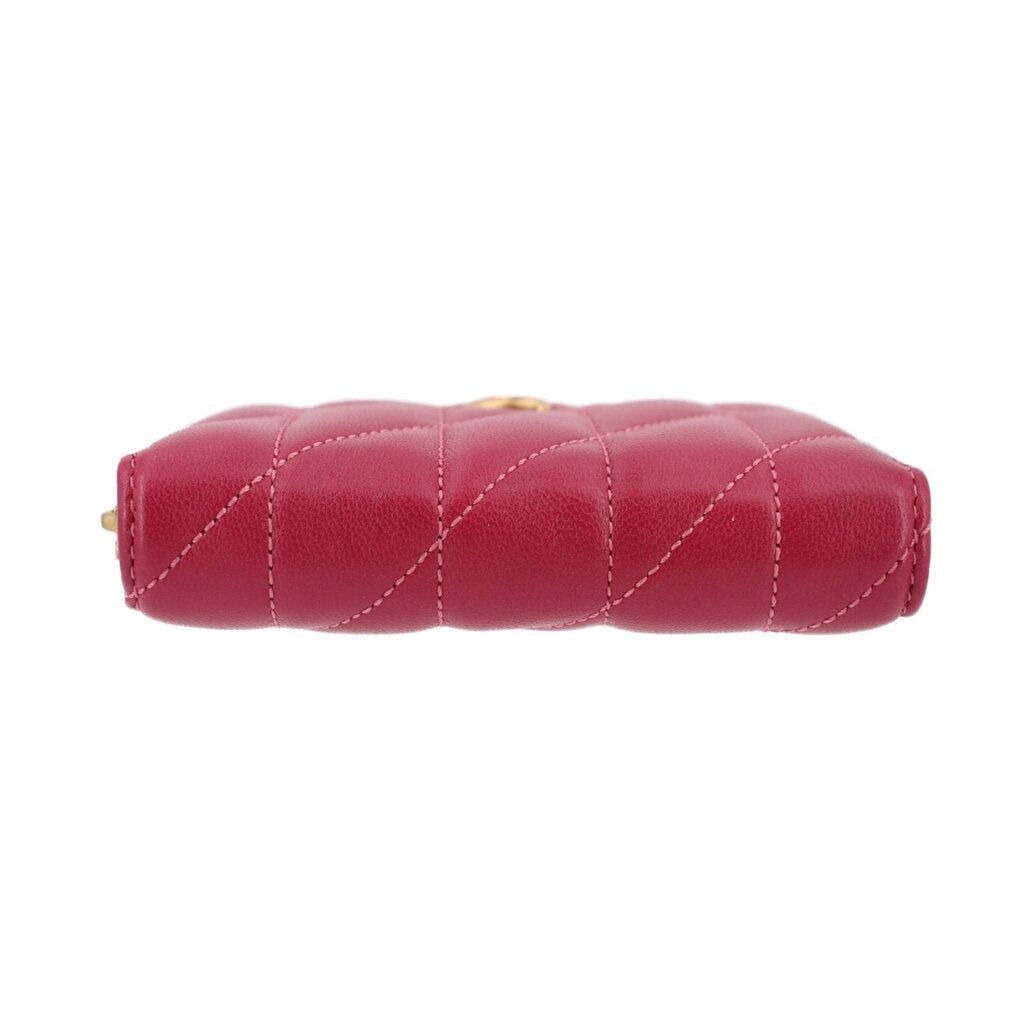 Fuchsia quilted zip wallet top view with gold zipper hardware.