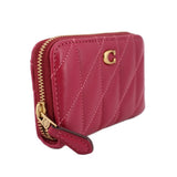Fuchsia quilted zip wallet with side pull tab and gold zipper hardware.