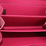 Fuchsia wallet interior with COACH logo and zip pocket lining.
