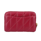 Fuchsia quilted zip wallet with gold C emblem and stitched paneling.