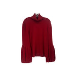 Red cashmere sweater with mock turtleneck and pleated bell sleeves