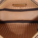 Inside view of tan perforated crossbody bag showing fabric lining and metal zipper tab