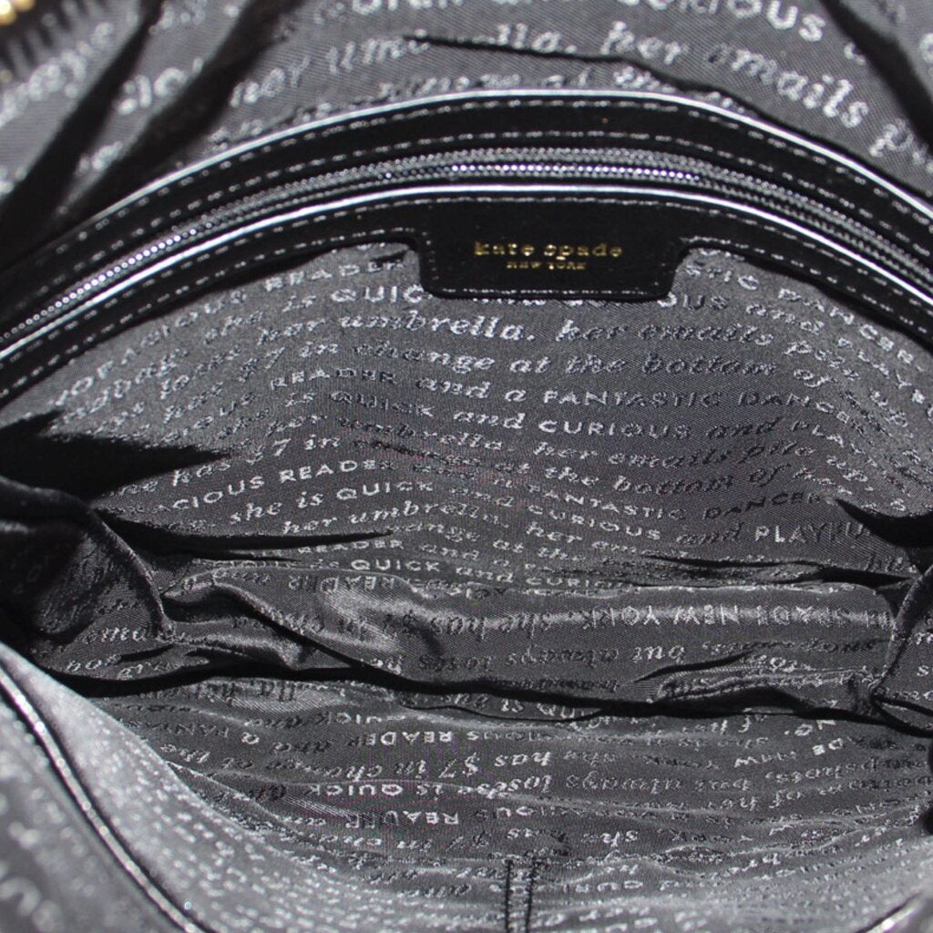 KATE SPADE AUBURN PLACE Cordelia black crossbody bag interior lining with printed text.