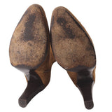 Boot soles and heels in suede, camel brown, showing textured wear