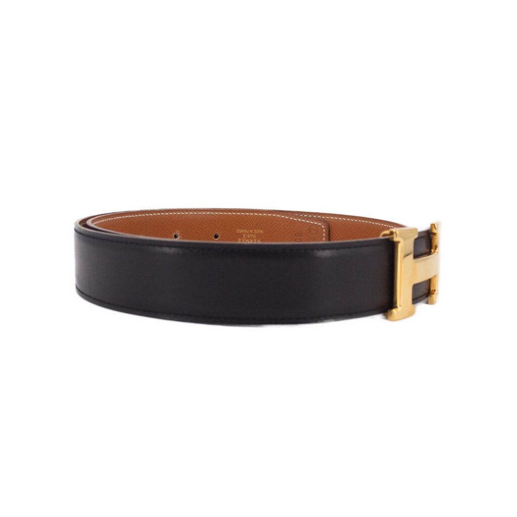 Reversible leather belt, black and tan, gold-tone buckle end view