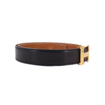 Reversible leather belt, black and tan, gold-tone buckle end view