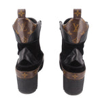 Black monogram high-top boots with padded heel and side logo panels