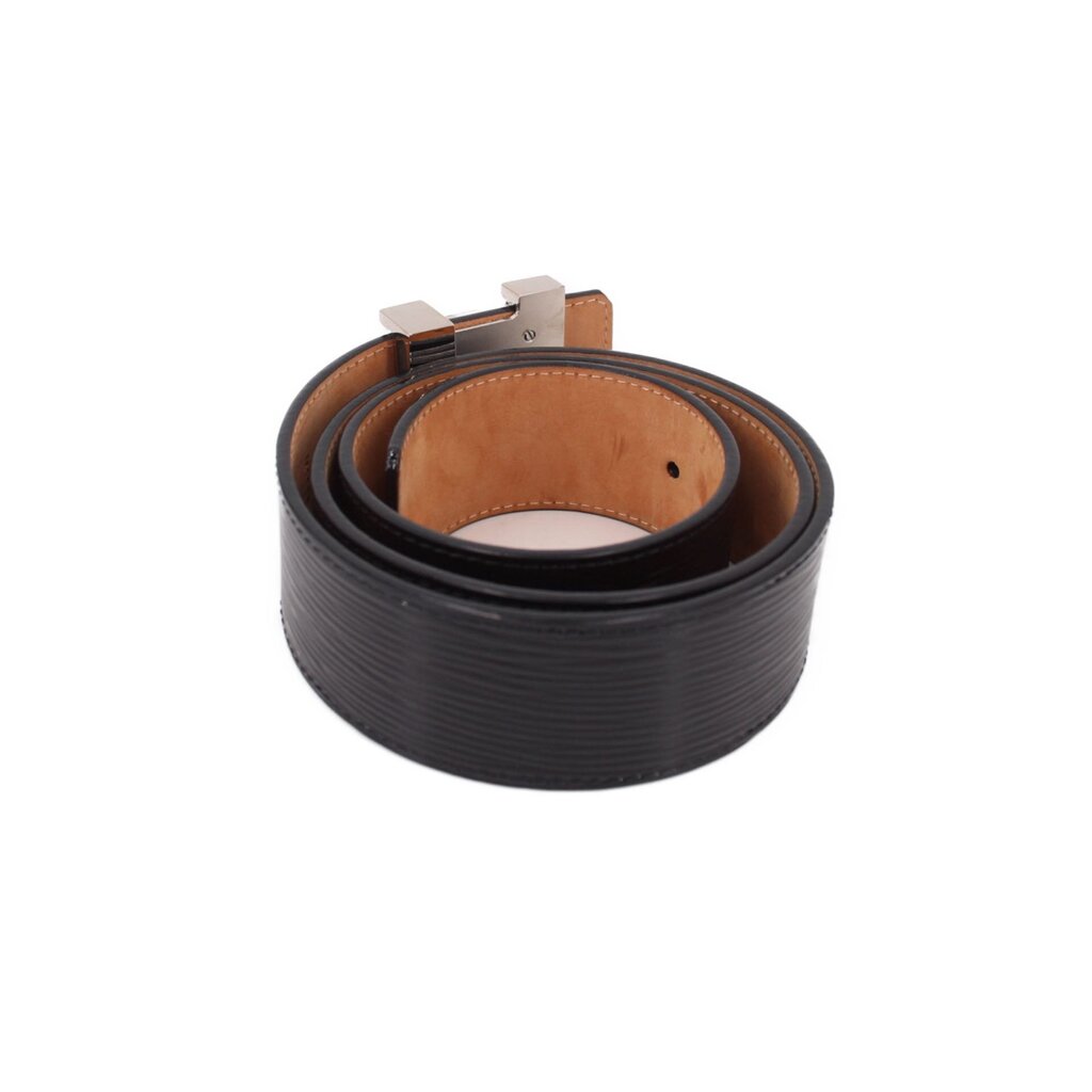 Black leather belt showing inner tan strap and silver buckle hardware