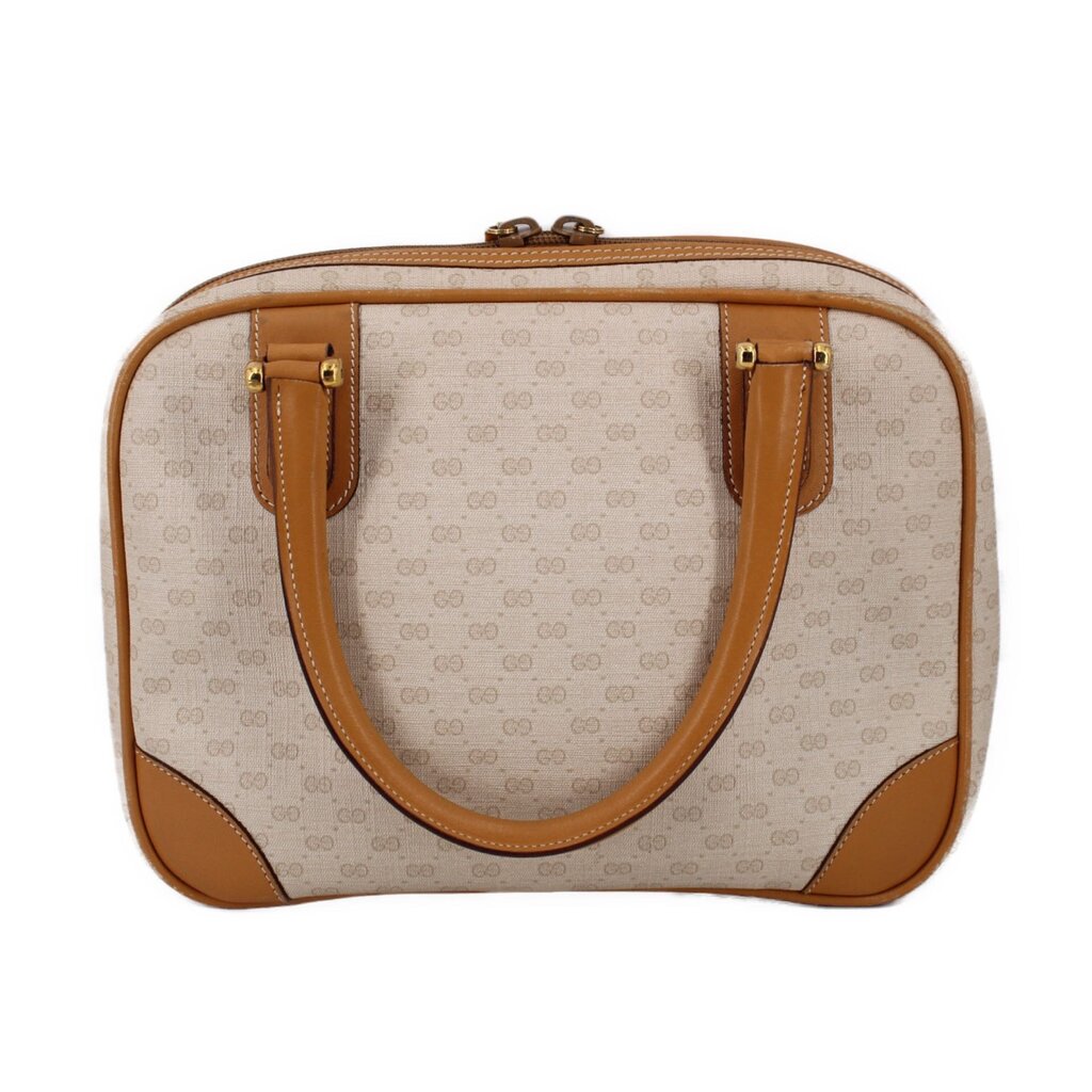 Beige vintage duffel-style top handle bag with tan leather trim and dual top handles