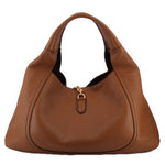 Brown leather Softbit shoulder bag with center clasp and curved hobo silhouette
