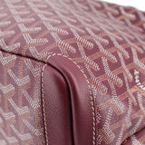 Maroon patterned canvas corner with leather trim and visible edge stitching