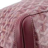 Maroon leather handle base with stitched seam on patterned canvas