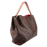 Louis Vuitton Monogram shoulder bag with brown exterior and leather top handles