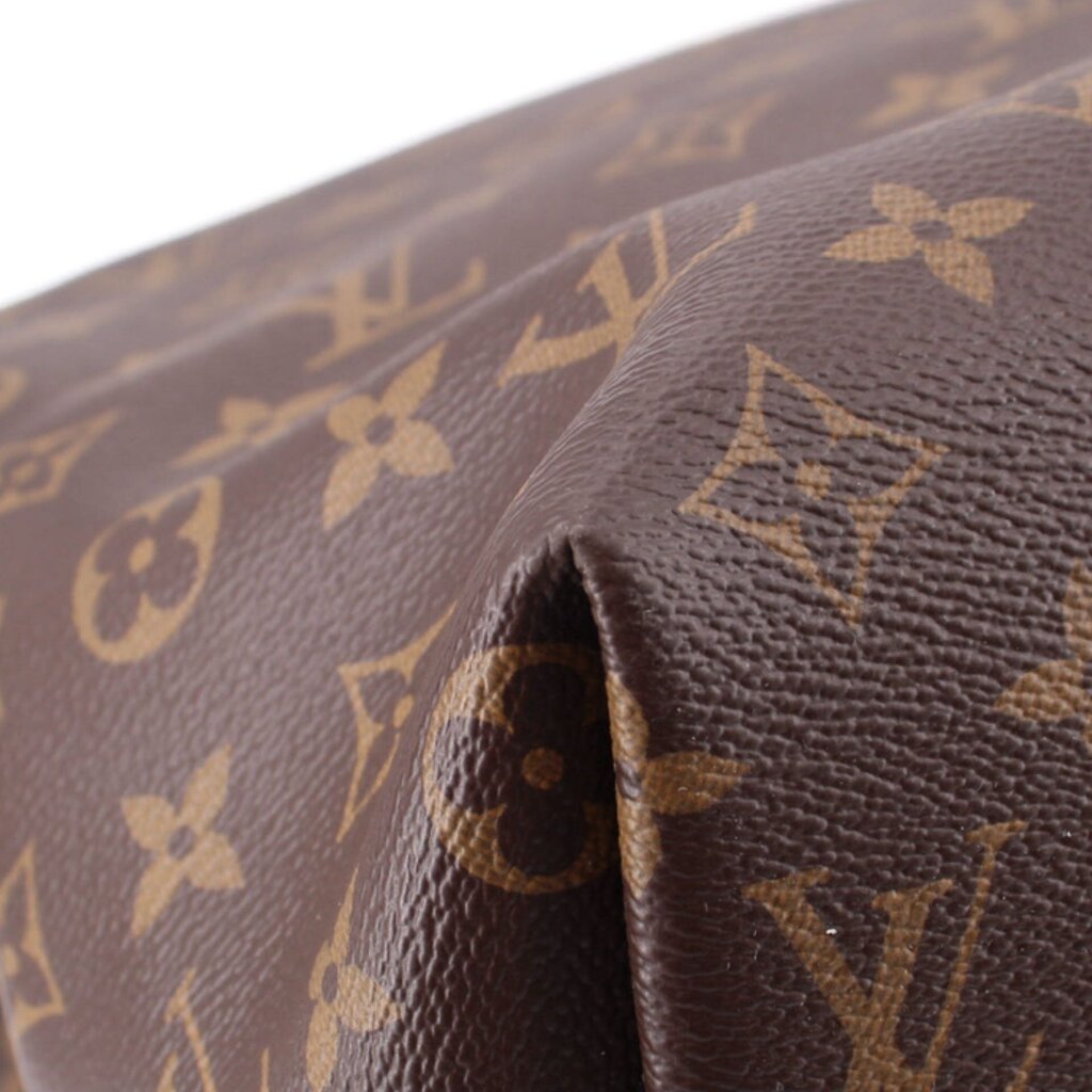 Brown Monogram leather corner close-up with textured grain and embossed pattern