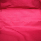 Red fabric interior lining of a Louis Vuitton Monogram shoulder bag