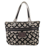 Black and beige op-art canvas shoulder bag with double handles and zip top