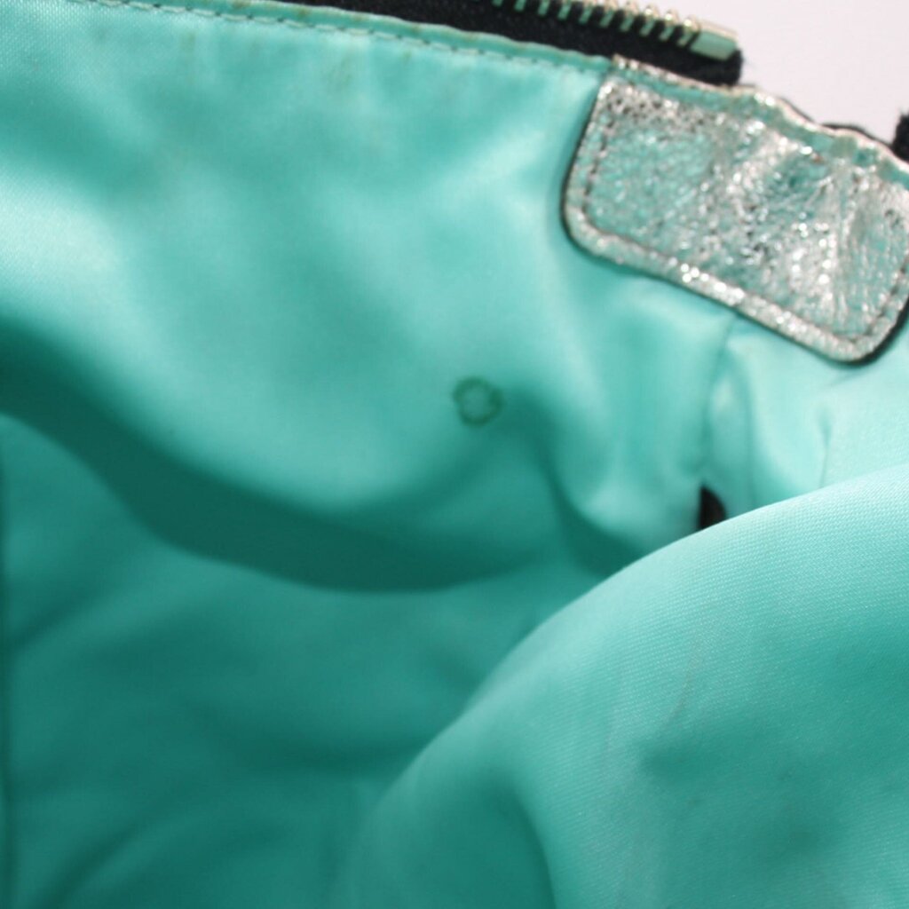 Teal inner pocket area with stitched tab detail inside shoulder bag