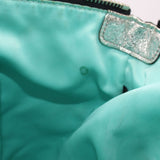 Teal inner pocket area with stitched tab detail inside shoulder bag