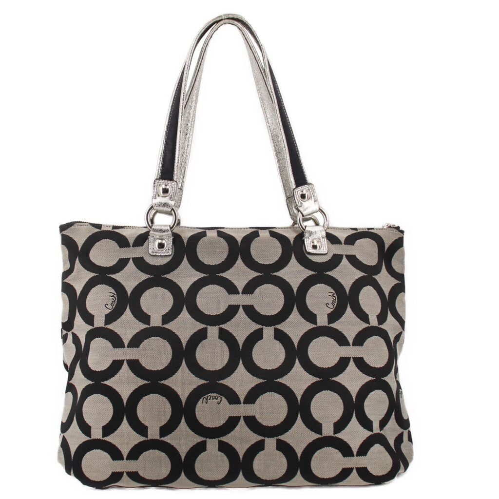 Black and beige op-art tote-style shoulder bag with top zip and metal buckles