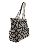 Black and beige op-art shoulder bag with twin handles and structured side panels
