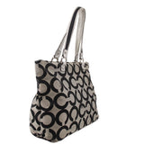 Black and beige op-art shoulder bag with twin handles and structured side panels