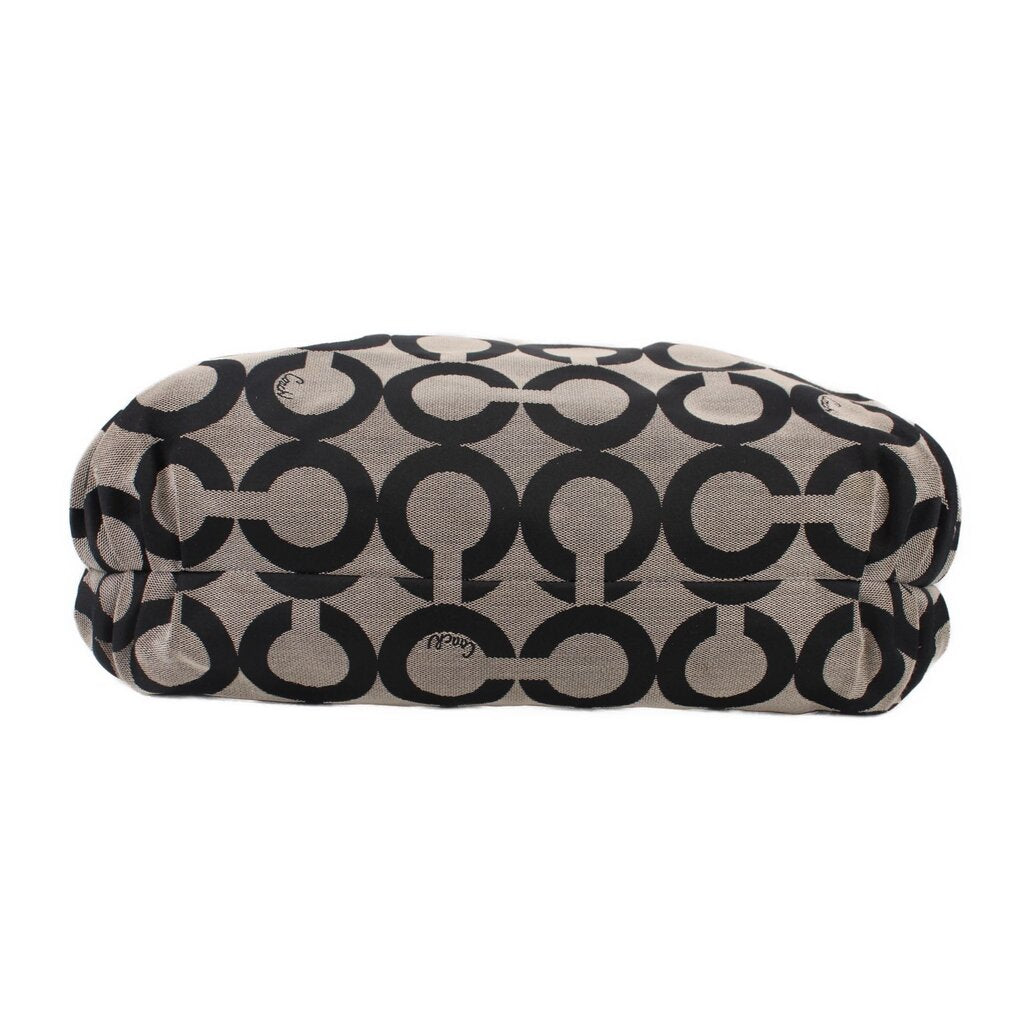 Black and beige op-art duffel-style shoulder bag with rounded top and small logo patch