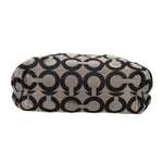 Black and beige op-art duffel-style shoulder bag with rounded top and small logo patch