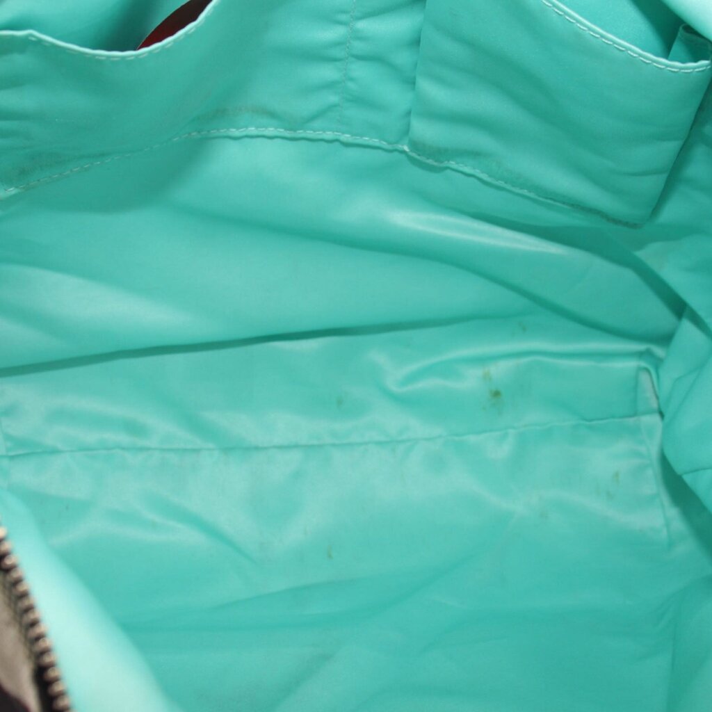 Teal fabric lining inside shoulder bag with stitched edges