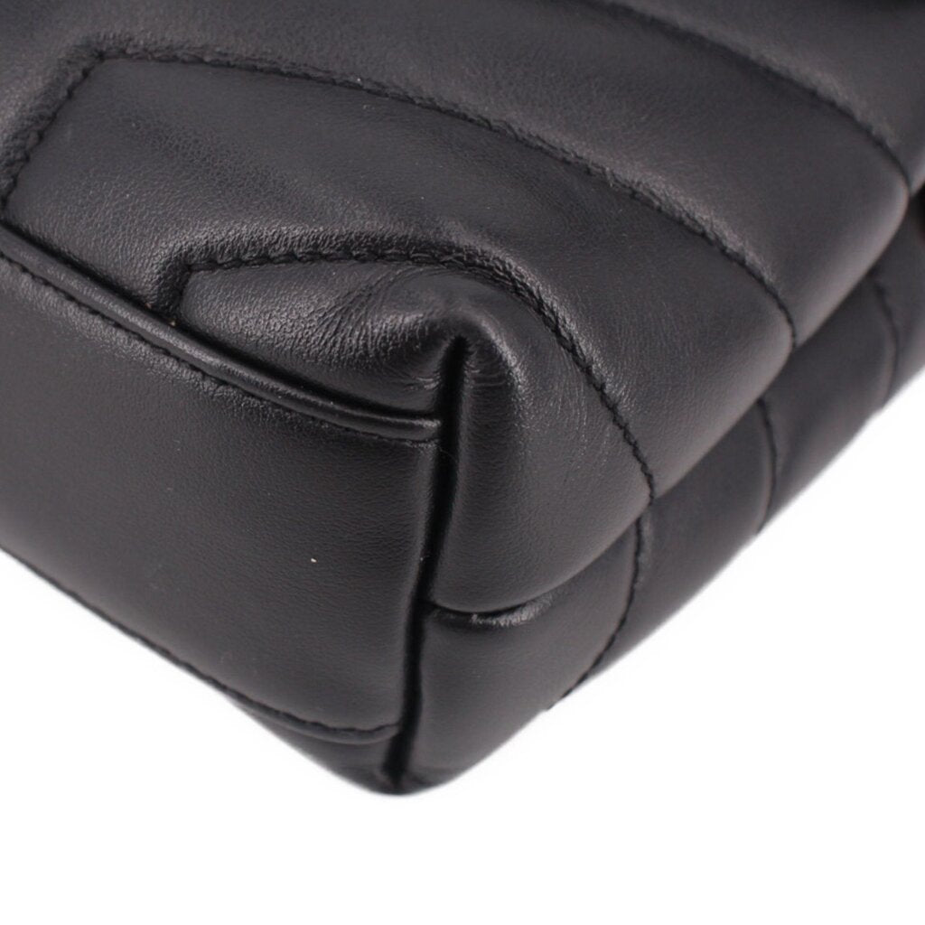 Black leather crossbody bag corner close-up with padded quilting