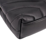 Black leather crossbody bag corner close-up with rounded quilting seam
