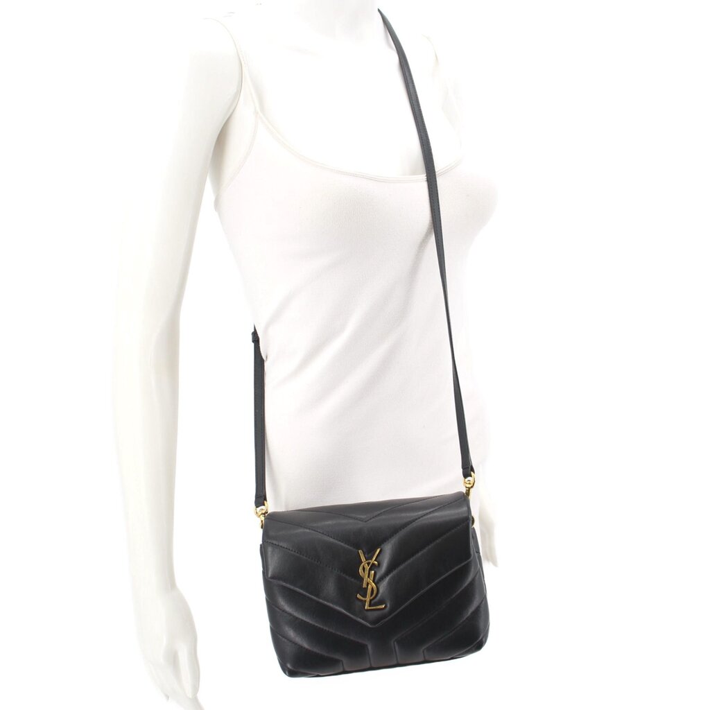 Black quilted leather crossbody bag worn on adjustable strap with YSL logo