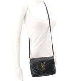 Black quilted leather crossbody bag worn on adjustable strap with YSL logo