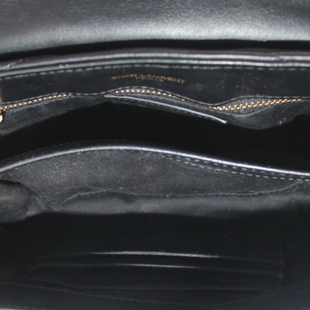 Black crossbody bag interior with stitched lining and zipper opening